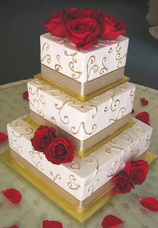 Square wedding cake with gold bow and red roses